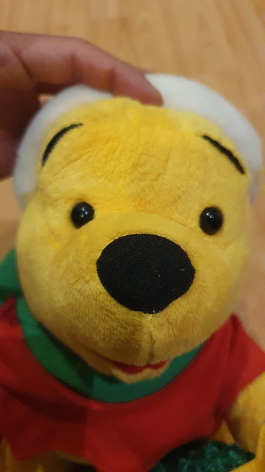 Original Disney Winnie the Pooh Christmas plush with movement and music. Never been used.